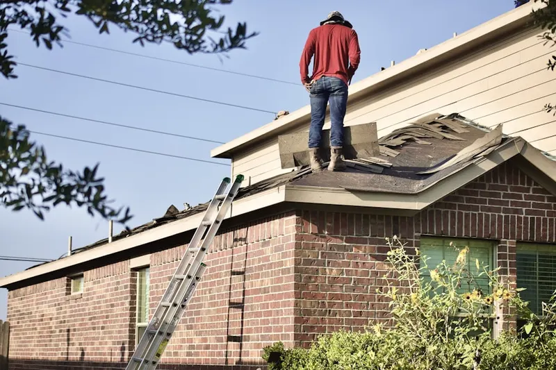 Professional roofer working on a residential roof in Loux Corner